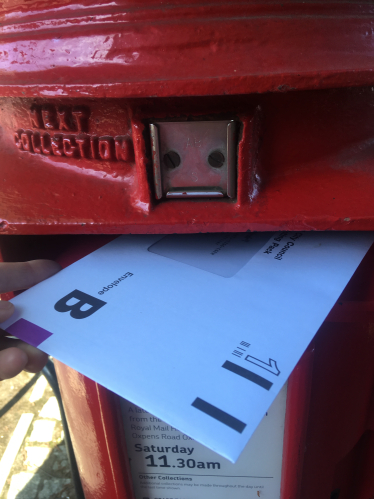 Postal vote being posted in post box